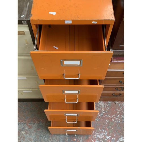 214 - An orange metal four drawer office filing cabinet - approx. 133cm high x 47cm wide x 62cm deep