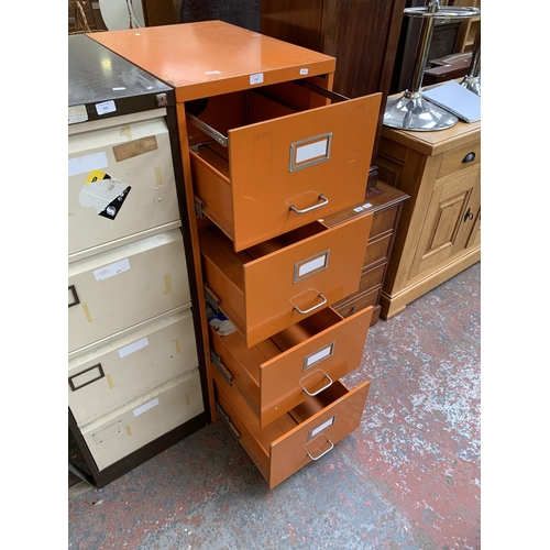 214 - An orange metal four drawer office filing cabinet - approx. 133cm high x 47cm wide x 62cm deep