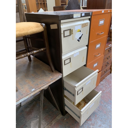 215 - A brown and cream metal four drawer office filing cabinet - approx. 132cm high x 46cm wide x 63cm de... 