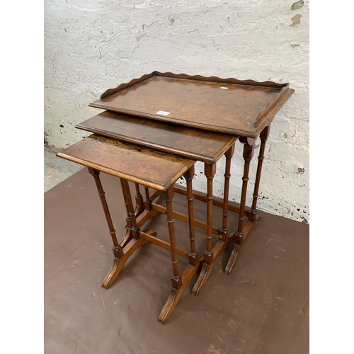 220 - A 19th century style burr walnut and mahogany nest of three tables - largest approx. 60cm high x 56c... 