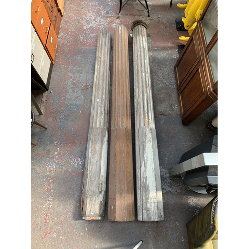 222 - Three 19th century pitch pine Corinthian pillars - largest approx. 281cm