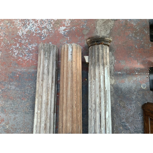 222 - Three 19th century pitch pine Corinthian pillars - largest approx. 281cm