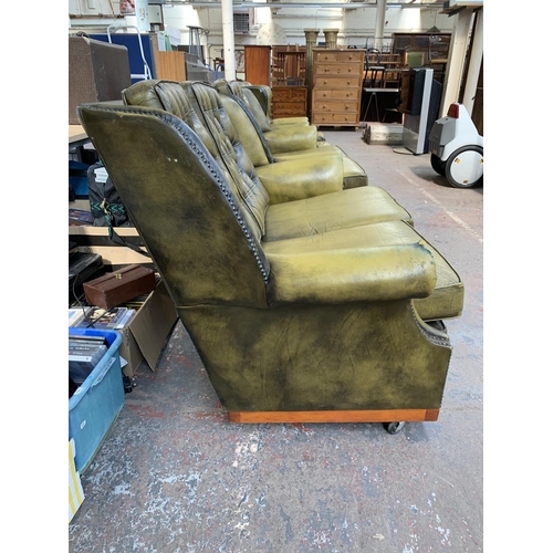 237 - An olive green leather Chesterfield four piece lounge suite comprising two reclining armchairs and t... 