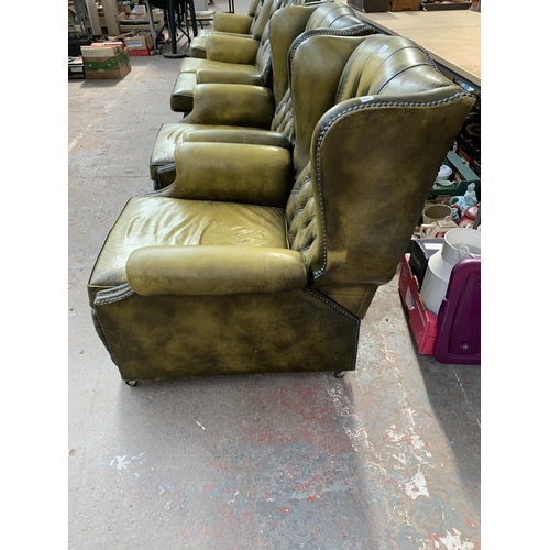 237 - An olive green leather Chesterfield four piece lounge suite comprising two reclining armchairs and t... 