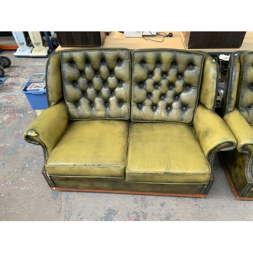 237 - An olive green leather Chesterfield four piece lounge suite comprising two reclining armchairs and t... 