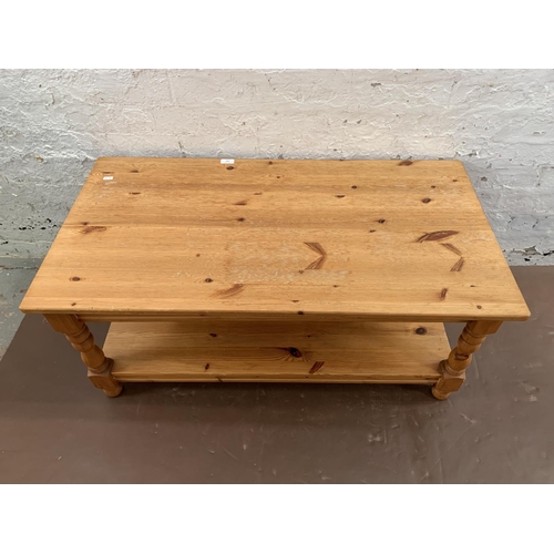 239 - A pine rectangular two tier coffee table - approx. 47cm high x 53cm wide x 105cm long