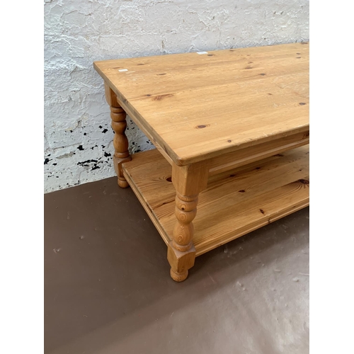 239 - A pine rectangular two tier coffee table - approx. 47cm high x 53cm wide x 105cm long