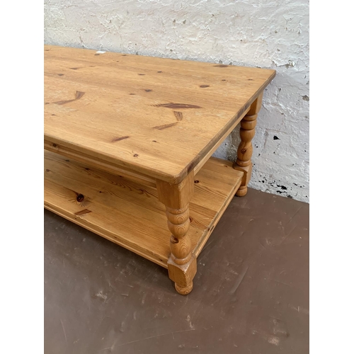 239 - A pine rectangular two tier coffee table - approx. 47cm high x 53cm wide x 105cm long