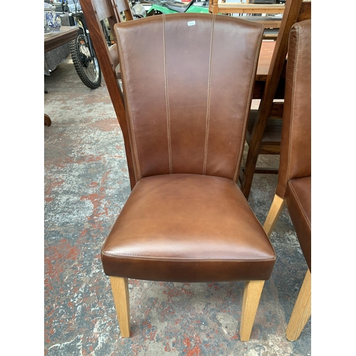 240 - Four modern brown leather dining chairs on oak supports