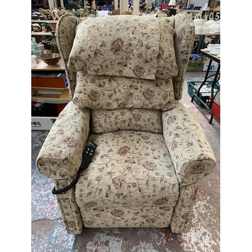 243 - An Ableworld 'The Cheshire' fabric upholstered riser recliner arm chair with remote and power supply... 