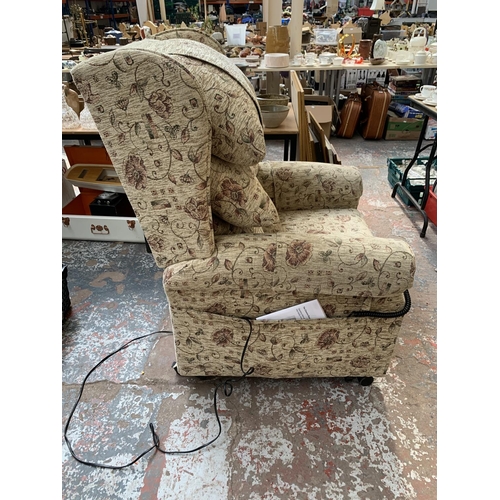 243 - An Ableworld 'The Cheshire' fabric upholstered riser recliner arm chair with remote and power supply... 