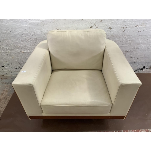 247 - A Dwell cream leather and walnut effect swivel arm chair - approx. 85cm high x 98cm wide x 88cm deep