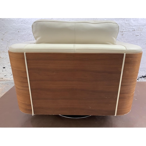 247 - A Dwell cream leather and walnut effect swivel arm chair - approx. 85cm high x 98cm wide x 88cm deep