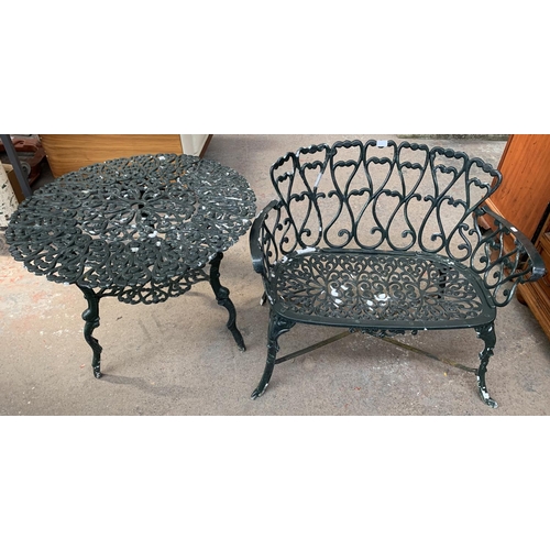 249 - Two pieces of Victorian style green painted cast metal garden furniture, one two seater bench and on... 