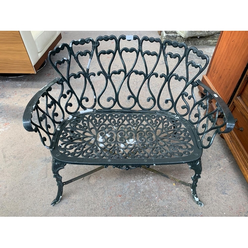 249 - Two pieces of Victorian style green painted cast metal garden furniture, one two seater bench and on... 