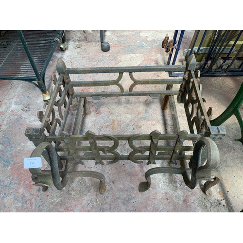 251 - A cast and wrought iron fire grate - approx. 36cm high x 63cm wide x 46cm deep