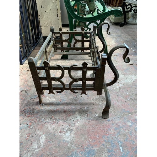 251 - A cast and wrought iron fire grate - approx. 36cm high x 63cm wide x 46cm deep