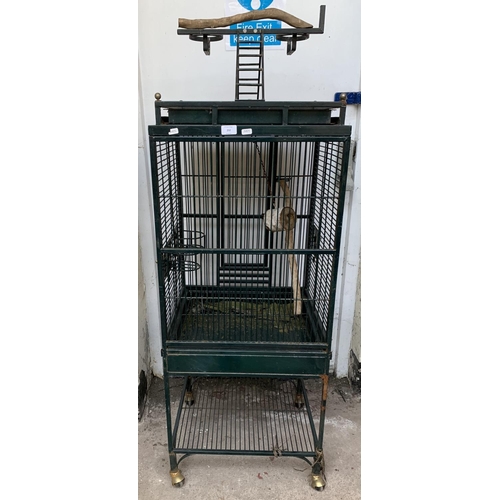 252 - A green painted metal bird cage on castors - approx. 149cm high x 46cm wide x 51cm deep