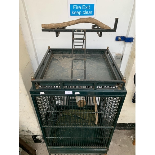 252 - A green painted metal bird cage on castors - approx. 149cm high x 46cm wide x 51cm deep