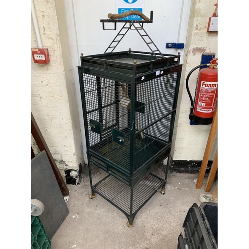 252 - A green painted metal bird cage on castors - approx. 149cm high x 46cm wide x 51cm deep