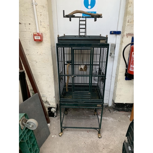 252 - A green painted metal bird cage on castors - approx. 149cm high x 46cm wide x 51cm deep