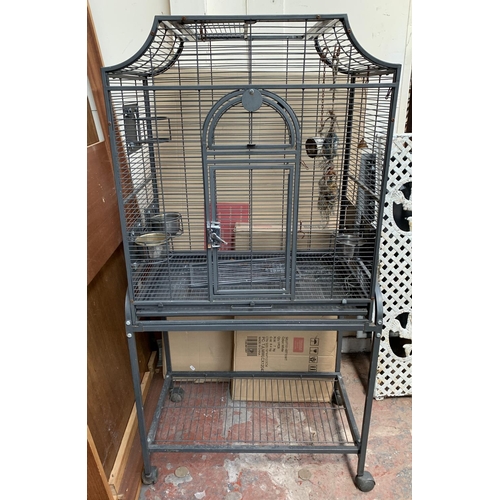 253 - A grey painted metal bird cage on castors - approx. 142cm high x 70cm wide x 45cm deep