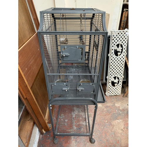 253 - A grey painted metal bird cage on castors - approx. 142cm high x 70cm wide x 45cm deep