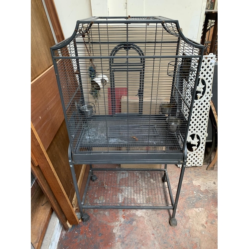 253 - A grey painted metal bird cage on castors - approx. 142cm high x 70cm wide x 45cm deep