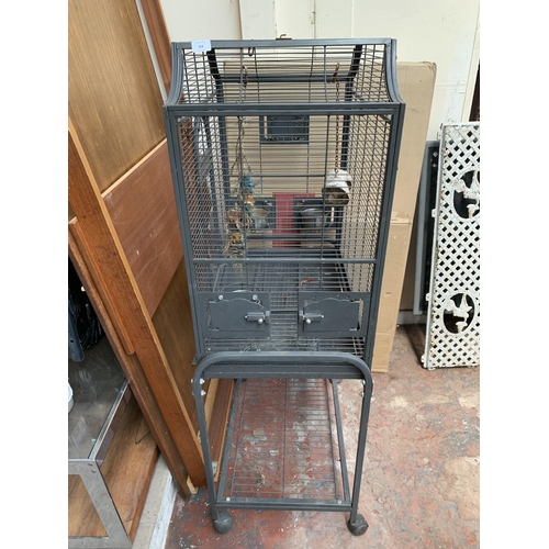 253 - A grey painted metal bird cage on castors - approx. 142cm high x 70cm wide x 45cm deep