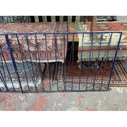 257 - Two blue painted wrought iron garden gates - approx. 97cm high x 130cm wide