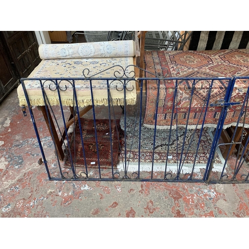 257 - Two blue painted wrought iron garden gates - approx. 97cm high x 130cm wide