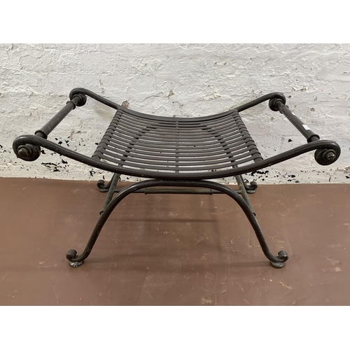 260 - A wrought iron garden stool - approx. 50cm high x 86cm wide x 49cm deep