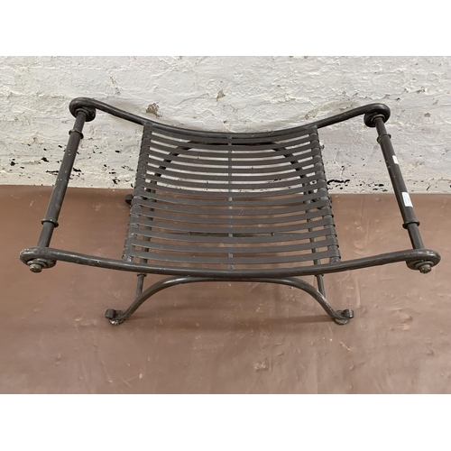 260 - A wrought iron garden stool - approx. 50cm high x 86cm wide x 49cm deep