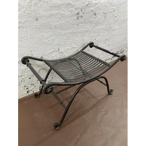 260 - A wrought iron garden stool - approx. 50cm high x 86cm wide x 49cm deep