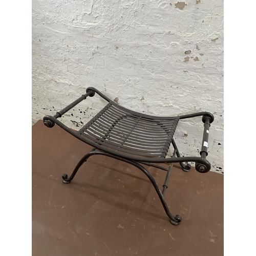 260 - A wrought iron garden stool - approx. 50cm high x 86cm wide x 49cm deep