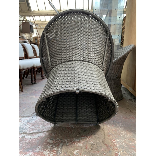 261 - A plastic rattan effect three piece garden furniture set comprising two chairs and one circular glas... 