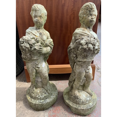 262 - A pair of cast stone garden statues - approx. 60cm high