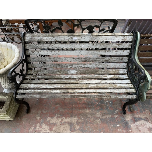 266 - A Victorian style cast iron and wooden slatted two seater garden bench - approx. 77cm high x 130cm w... 