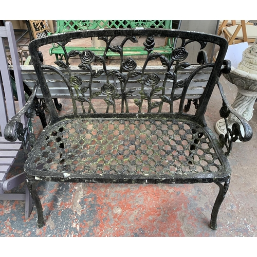 273 - A black painted cast metal two seater garden bench - approx. 94cm high x 108cm wide x 46cm deep