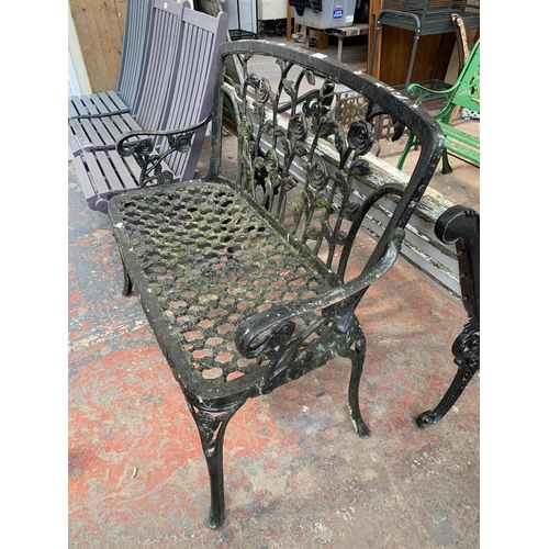 273 - A black painted cast metal two seater garden bench - approx. 94cm high x 108cm wide x 46cm deep