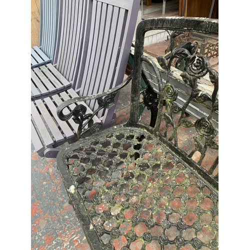 273 - A black painted cast metal two seater garden bench - approx. 94cm high x 108cm wide x 46cm deep