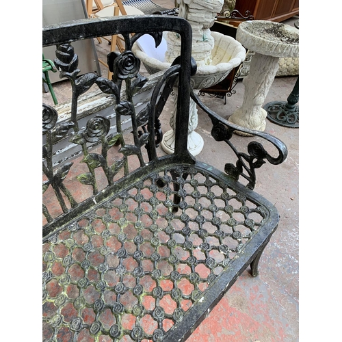 273 - A black painted cast metal two seater garden bench - approx. 94cm high x 108cm wide x 46cm deep