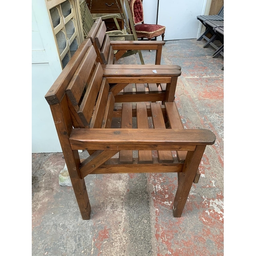 277 - A pair of pine slatted garden armchairs - approx. 80cm high x 67cm wide x 59cm deep