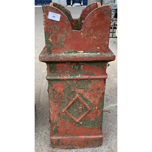 280 - A red painted cast stone chimney pot - approx. 70cm high x 28cm wide x 30cm deep