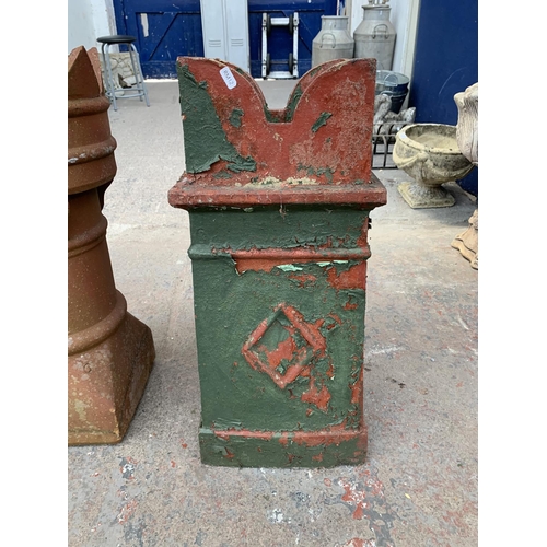 280 - A red painted cast stone chimney pot - approx. 70cm high x 28cm wide x 30cm deep