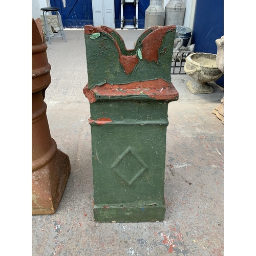 280 - A red painted cast stone chimney pot - approx. 70cm high x 28cm wide x 30cm deep