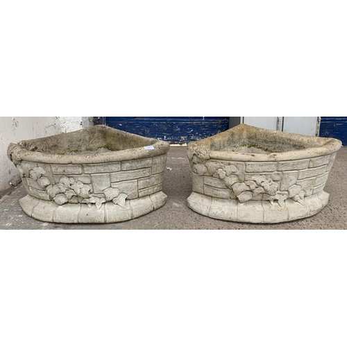 289 - A pair of cast stone corner garden planters - approx. 29cm high x 62cm wide x 43cm deep