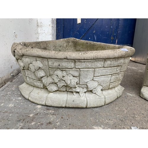 289 - A pair of cast stone corner garden planters - approx. 29cm high x 62cm wide x 43cm deep