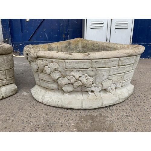 289 - A pair of cast stone corner garden planters - approx. 29cm high x 62cm wide x 43cm deep