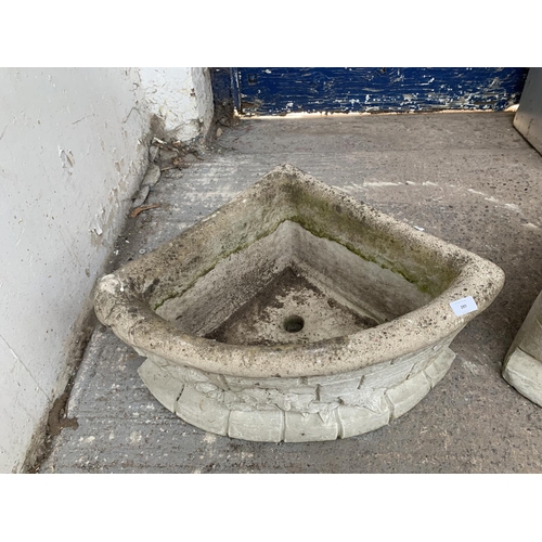 289 - A pair of cast stone corner garden planters - approx. 29cm high x 62cm wide x 43cm deep